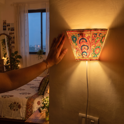 Handpainted Tholu Bommalata Leather Wall Lamp (Small), lit in a home in the evening, AI visual of the light, iTokri