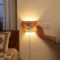 Handpainted Tholu Bommalata Leather Wall Lamp (Small), lit in a home in the evening, AI visual of the light, iTokri