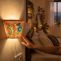 Handpainted Tholu Bommalata Leather Wall Lamp (Small), lit in a home in the evening, AI visual of the light, iTokri