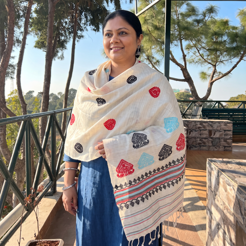 White Handspun Handwoven Pure Eri Silk Aari Hand Embroidered Shawl of Assam, worn by a model, AI visual of the shawl, iTokri