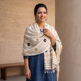White Handspun Handwoven Pure Eri Silk Aari Hand Embroidered Shawl of Assam, worn by a model, AI visual of the shawl, iTokri