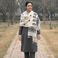 White Handspun Handwoven Pure Eri Silk Aari Hand Embroidered Shawl of Assam, worn by a model, AI visual of the shawl, iTokri