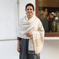 White Handspun Handwoven Pure Eri Silk Aari Hand Embroidered Shawl of Assam, worn by a model, AI visual of the shawl, iTokri