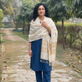 White Handspun Handwoven Pure Eri Silk Aari Hand Embroidered Shawl of Assam, worn by a model, AI visual of the shawl, iTokri
