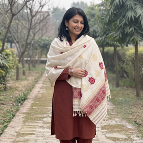 White Handspun Handwoven Pure Eri Silk Aari Hand Embroidered Shawl of Assam, worn by a model, AI visual of the shawl, iTokri