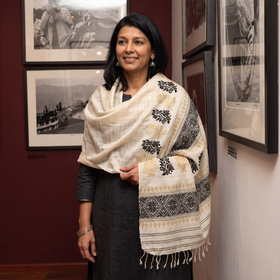White Handspun Handwoven Pure Eri Silk Aari Hand Embroidered Shawl of Assam, worn by a model, AI visual of the shawl, iTokri