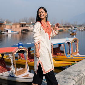 White Handwoven Aari Hand Embroidered Kashmiri Merino Wool Pheran, worn by a model, AI visual of the pheran, iTokri