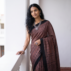 Peach Handwoven Merino Wool Natural Dyed Hand Block Print Ajrakh Saree, draped and worn by a woman, AI visual of the saree, iTokri