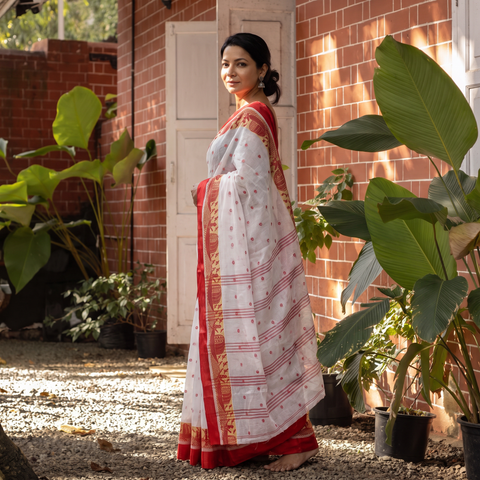 White Handwoven Pure Cotton Phulia Jamdani Saree for Durga Puja, draped and worn by a woman, AI visual of the saree, iTokri