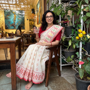 Off White Handwoven Pure Cotton Phulia Jamdani Saree for Durga Puja, draped and worn by a woman, AI visual of the saree, iTokri