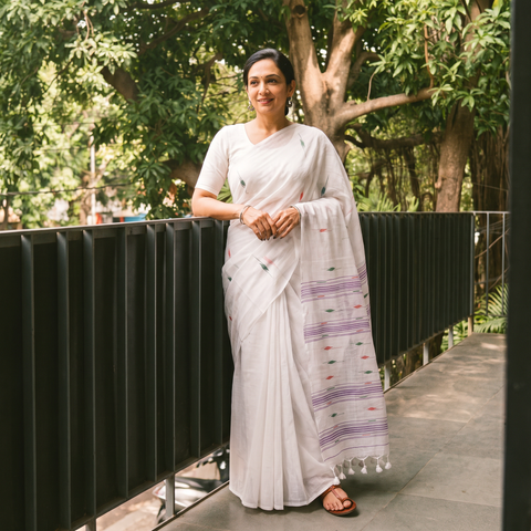 White Handwoven Pure Cotton Phulia Jamdani Saree for Durga Puja, draped and worn by a woman, AI visual of the saree, iTokri