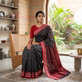 Black Ikat Handloom Cotton Sambalpuri Saree, draped and worn by a woman, AI visual of the saree, iTokri