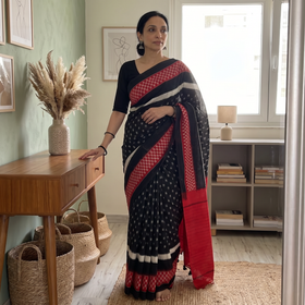 Black Ikat Handloom Cotton Sambalpuri Saree, draped and worn by a woman, AI visual of the saree, iTokri