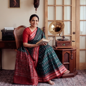 Green Ikat Handloom Cotton Sambalpuri Saree, draped and worn by a woman, AI visual of the saree, iTokri