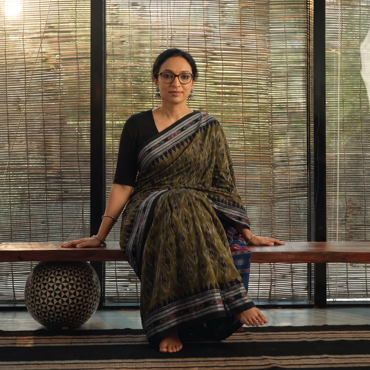Green Ikat Handloom Cotton Sambalpuri Saree, draped and worn by a woman, AI visual of the saree, iTokri