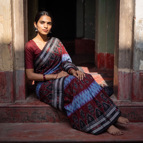 Maroon Ikat Handloom Pure Cotton Sambalpuri Saree, draped and worn by a woman, AI visual of the saree, iTokri