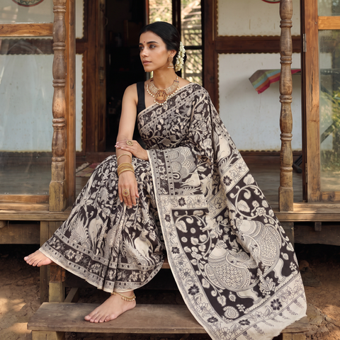 Beige Kalamkari Printed Cotton Saree, draped and worn by a woman, AI visual of the saree, iTokri
