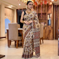 Beige Kalamkari Printed Cotton Saree, draped and worn by a woman, AI visual of the saree, iTokri