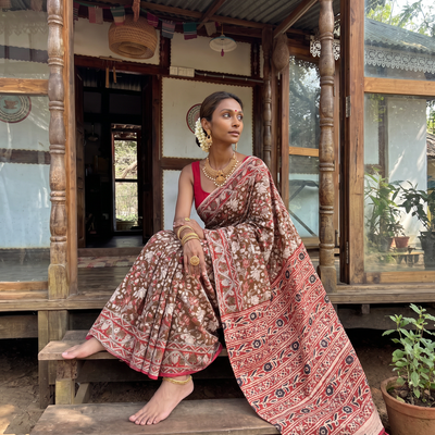Brown Kalamkari Printed Cotton Saree, draped and worn by a woman, AI visual of the saree, iTokri