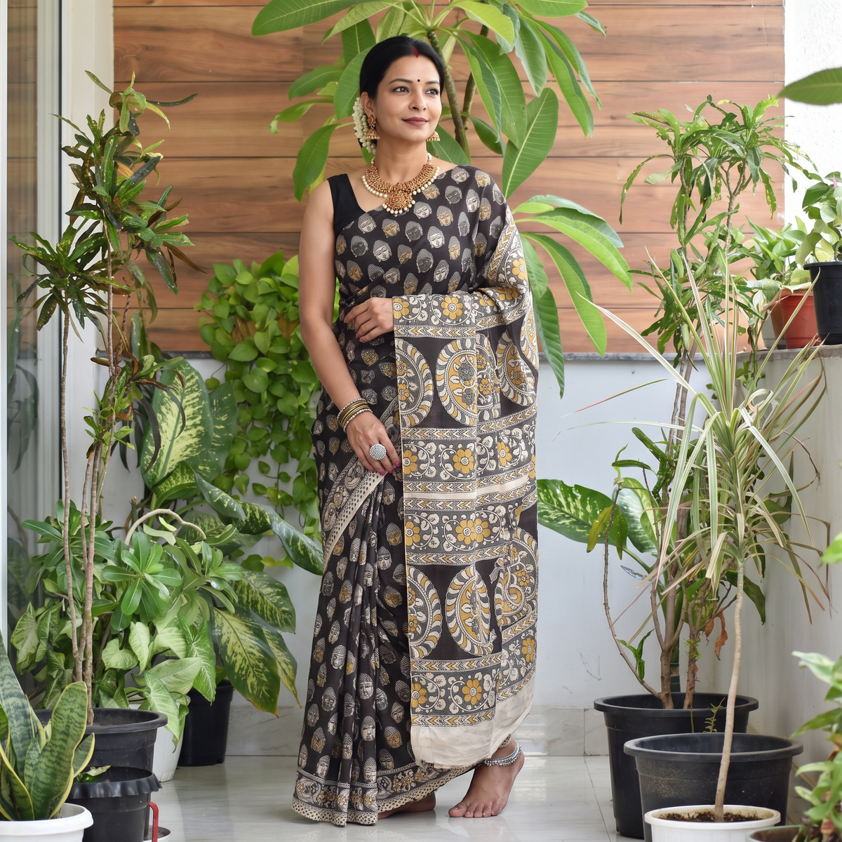 Black Kalamkari Printed Silk Cotton Saree, draped and worn by a woman, AI visual of the saree, iTokri