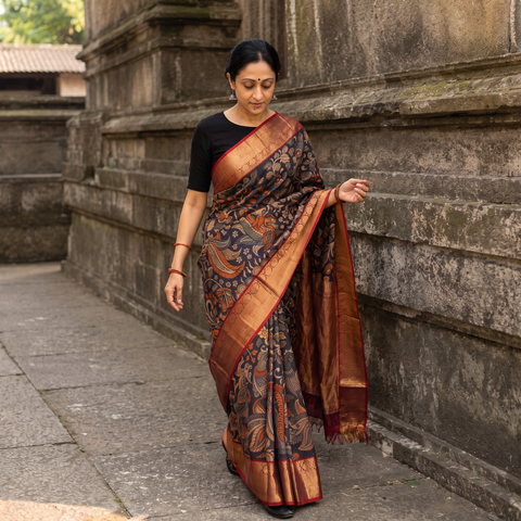 Black Kanjeevaram Pure Handloom Mulberry Silk Handpainted Srikalahasti Pen Kalamkari Saree with Zari Work, draped and worn by a woman, AI visual of the saree, iTokri