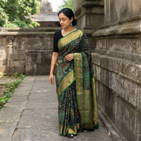 Green Kanjeevaram Pure Handloom Mulberry Silk Handpainted Srikalahasti Pen Kalamkari Saree with Zari Work, draped and worn by a woman, AI visual of the saree, iTokri