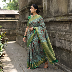 Green Kanjeevaram Pure Handloom Mulberry Silk Handpainted Srikalahasti Pen Kalamkari Saree with Zari Work, draped and worn by a woman, AI visual of the saree, iTokri