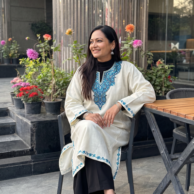 White Kashmiri Sozni Hand Embroidered Handwoven Merino Wool Pheran, worn by a model, AI visual of the pheran, iTokri
