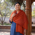 Orange Kashmiri Sozni Hand Embroidered Pure Handwoven Merino Wool Shawl, worn by a model, AI visual of the shawl, iTokri