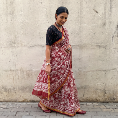 Red Kota Doria cotton saree with Sanganeri block print, draped and worn by a woman, AI visual of the saree, iTokri