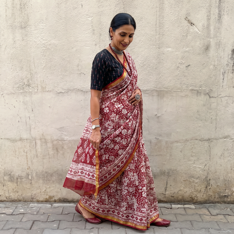 Red Kota Doria cotton saree with Sanganeri block print, draped and worn by a woman, AI visual of the saree, iTokri
