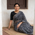 Black Kota Doria Cotton Hand Batik Print Saree, draped and worn by a woman, AI visual of the saree, iTokri