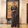 Black Kota Doria Cotton Hand Batik Print Saree, draped and worn by a woman, AI visual of the saree, iTokri