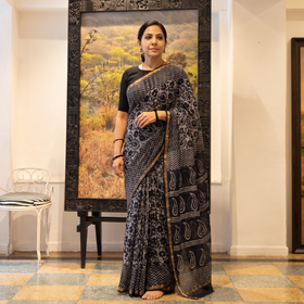 Black Kota Doria Cotton Hand Batik Print Saree, draped and worn by a woman, AI visual of the saree, iTokri