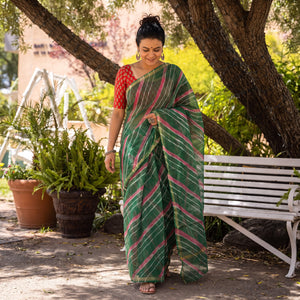 Green Nazaakat Kota Doria Cotton Plain Saree with Blouse Piece & Earrings, draped and worn by a woman, AI visual of the saree, iTokri