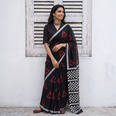Black Sanganeri hand block print Kota Doria cotton saree with bold geometric motifs, draped and worn by a woman, AI visual of the saree, iTokri