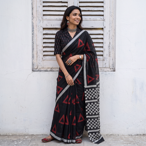 Black Sanganeri hand block print Kota Doria cotton saree with bold geometric motifs, draped and worn by a woman, AI visual of the saree, iTokri