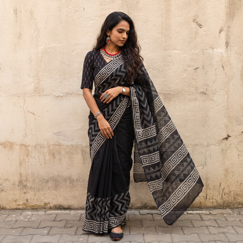Black Sanganeri hand block print Kota Doria cotton saree with bold geometric motifs, draped and worn by a woman, AI visual of the saree, iTokri