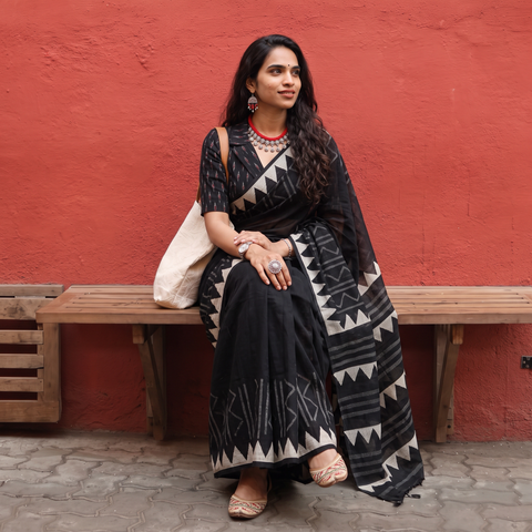 Black Sanganeri hand block print Kota Doria cotton saree with bold geometric motifs, draped and worn by a woman, AI visual of the saree, iTokri