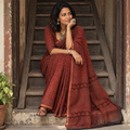 Rust red Kutch Ajrakh hand block print natural dyed Kota Doria cotton saree, draped and worn by a woman, AI visual of the saree, iTokri
