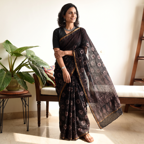 Black Kutch Ajrakh hand block print natural dyed Kota Doria cotton saree, draped and worn by a woman, AI visual of the saree, iTokri