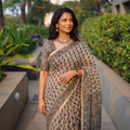 Beige Kutch Ajrakh hand block print natural dyed Kota Doria cotton saree, draped and worn by a woman, AI visual of the saree, iTokri