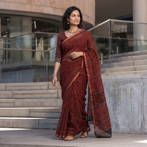 Maroon Kutch Ajrakh hand block print natural dyed Kota Doria cotton saree, draped and worn by a woman, AI visual of the saree, iTokri