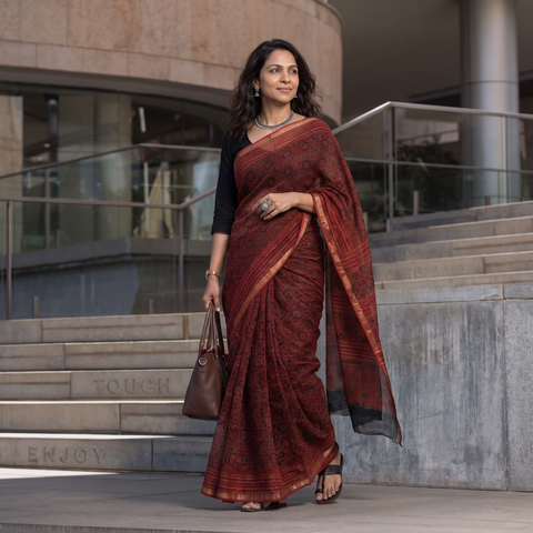Maroon Kutch Ajrakh hand block print natural dyed Kota Doria cotton saree, draped and worn by a woman, AI visual of the saree, iTokri