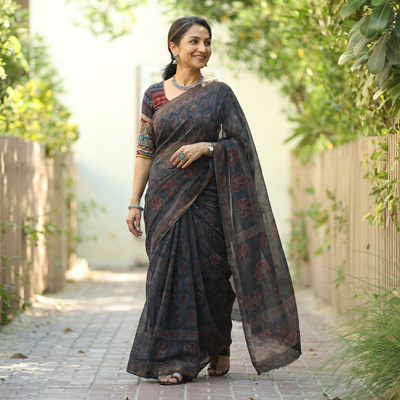 Black Kutch Ajrakh hand block print natural dyed Kota Doria cotton saree, draped and worn by a woman, AI visual of the saree, iTokri