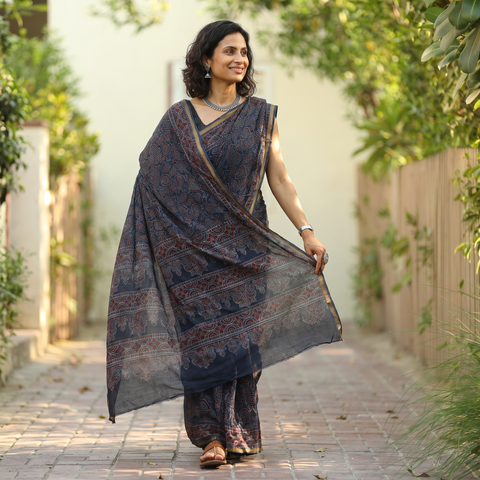 Indigo blue Kutch Ajrakh hand block print natural dyed Kota Doria cotton saree, draped and worn by a woman, AI visual of the saree, iTokri