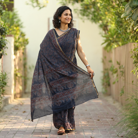 Indigo blue Kutch Ajrakh hand block print natural dyed Kota Doria cotton saree, draped and worn by a woman, AI visual of the saree, iTokri