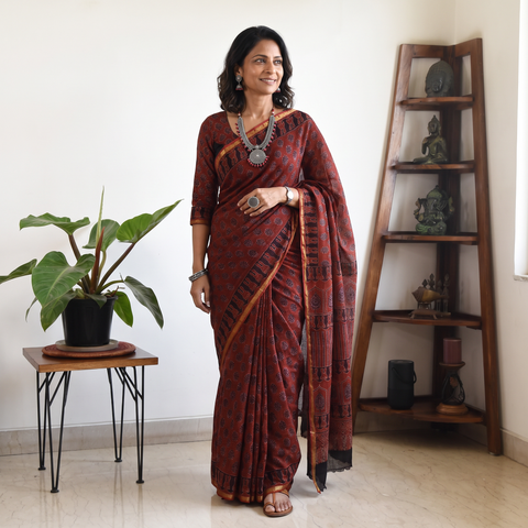 Maroon Kutch Ajrakh hand block print natural dyed Kota Doria cotton saree, draped and worn by a woman, AI visual of the saree, iTokri