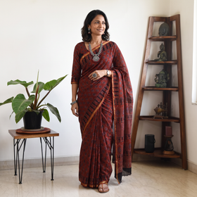 Maroon Kutch Ajrakh hand block print natural dyed Kota Doria cotton saree, draped and worn by a woman, AI visual of the saree, iTokri
