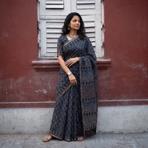 Black Kutch Ajrakh hand block print natural dyed Kota Doria cotton saree, draped and worn by a woman, AI visual of the saree, iTokri